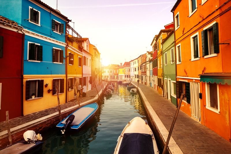 Beautiful Sunset with Boats, Buildings and Water. Sun Light